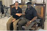 Allen Organ District Manager Bruce Rohrbach shaking hands with Allen's Nigeria Representative, Lanre Delano, on a successful installation.
